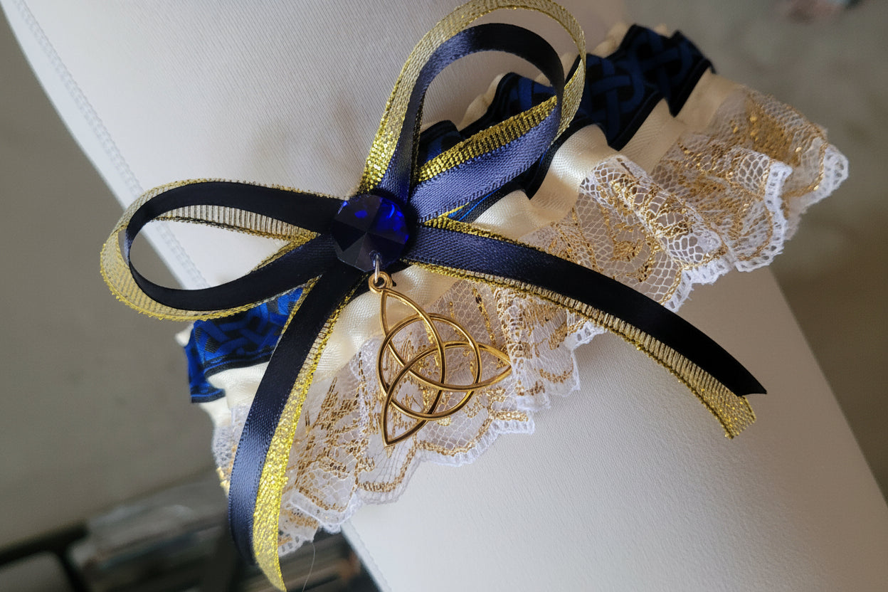 Decorative garter with black, gold, and blue ribbons on a white background